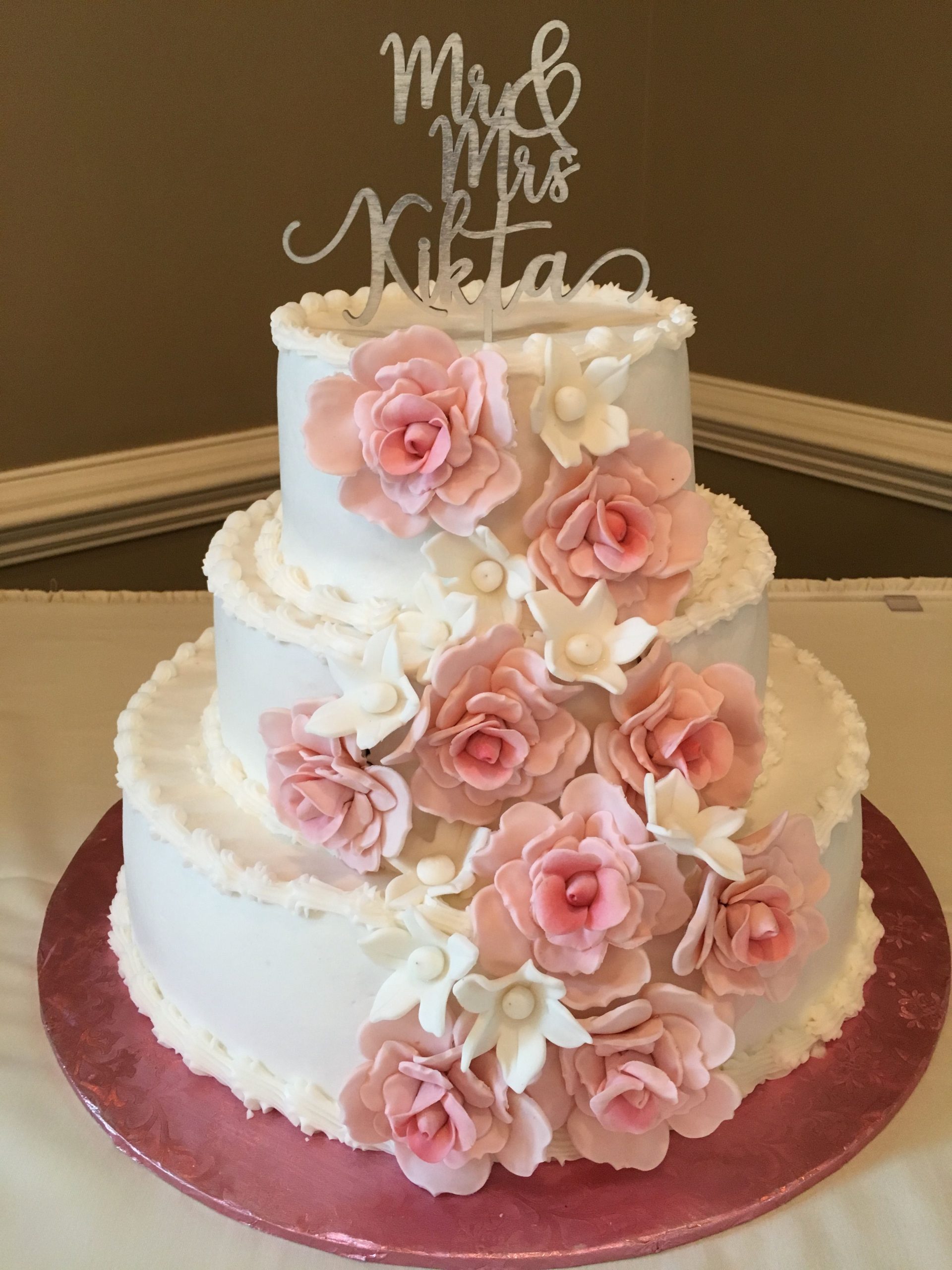 A 3 tier butter cream wedding cake with fondant flowers made by our ...
