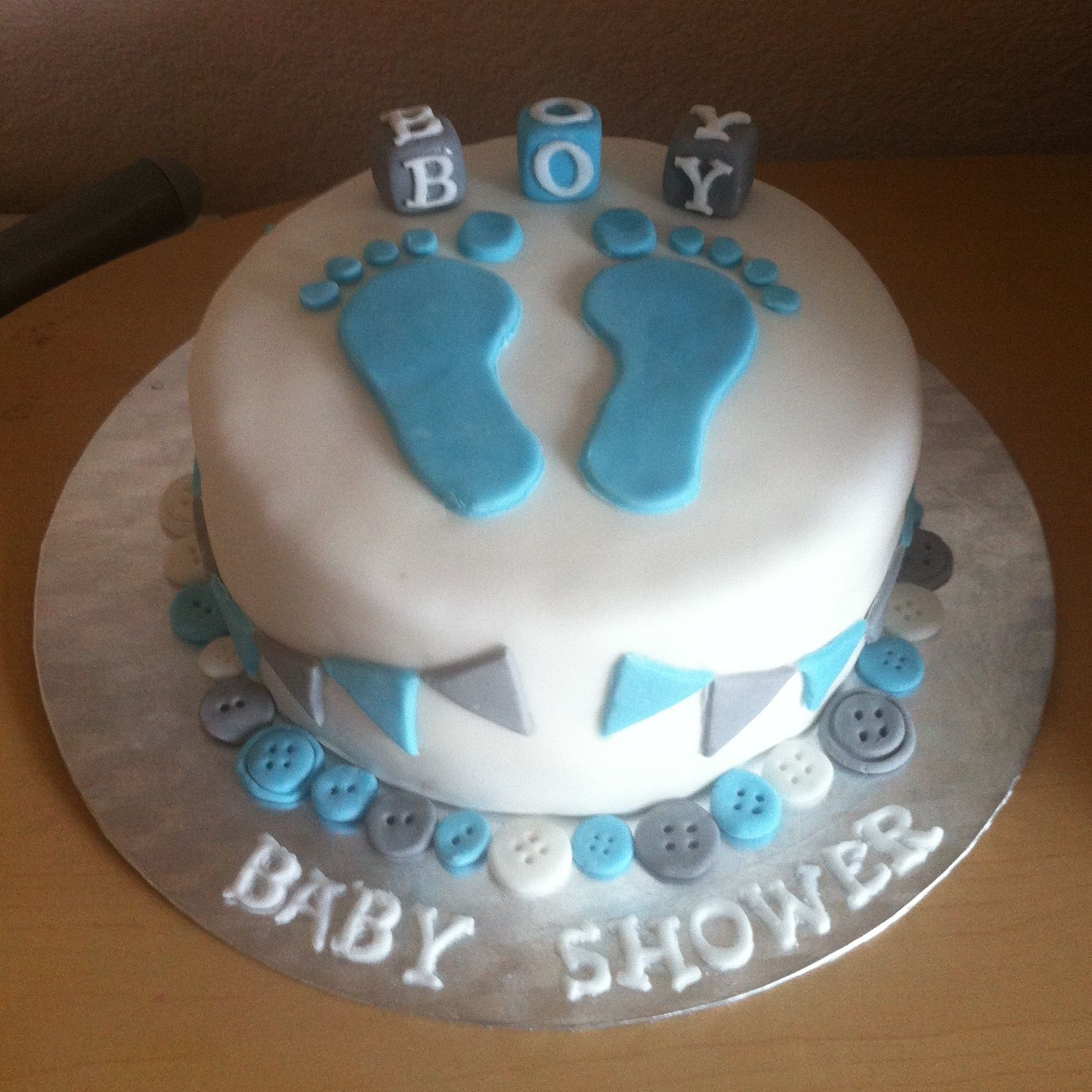 Baby boy baby shower cake with fondant footprints, blocks, bunting and ...