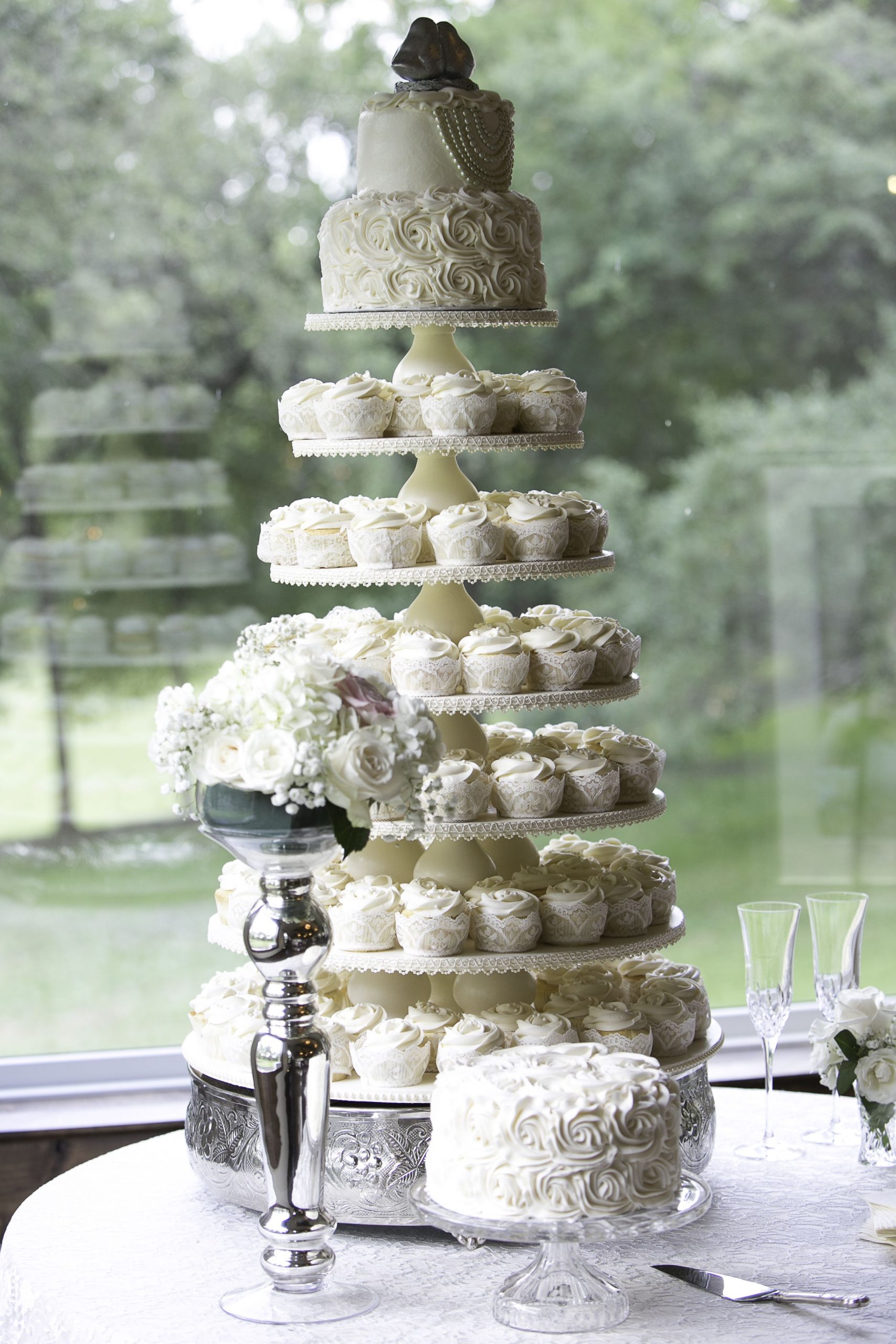 Wedding cupcake stand with lace and pearl trim and small cake on top ...